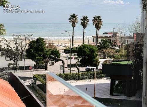 a balcony with a view of the beach and a piano at Amamare Luxury Room in Giulianova