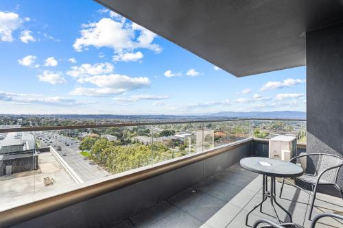 a balcony with a table and chairs and a view at Skygarden On The Glen in Glen Waverley
