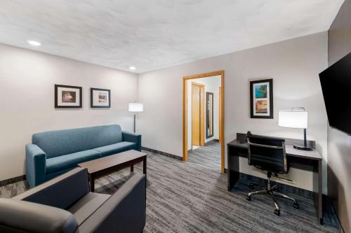 a living room with a couch and a desk with a computer at Quality Inn & Suites Munising in Wetmore
