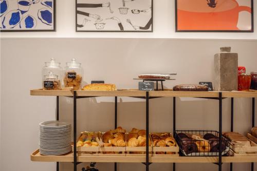 a shelf filled with lots of different types of bread at Hotel Santiago Plaza Affiliated by Meliá in Santiago de Compostela