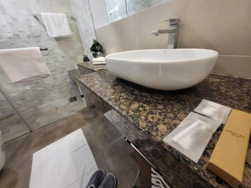 a bathroom with a white bowl sink on a counter at Goldcrest - 1 Bedroom Luxury Apartment - Lahore in Lahore