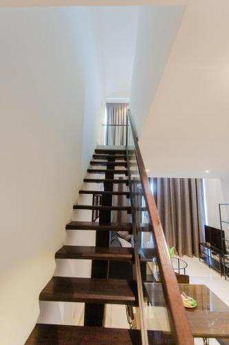 a staircase in a house with a table at Accra Luxury Apartments at Embassy Gardens in Accra
