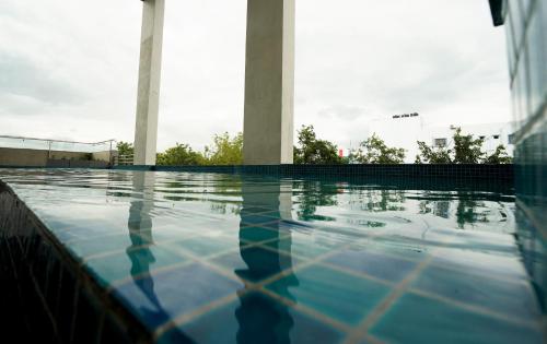 a close up of a swimming pool with columns at The Grand Sona in Deoghar