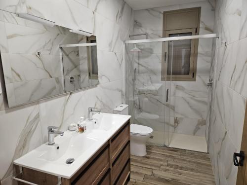 a bathroom with a sink and a shower and a toilet at Utopia in Puigventos