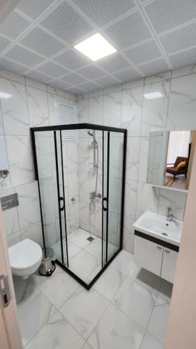a bathroom with a shower and a toilet and a sink at CZG Suit in Alanya