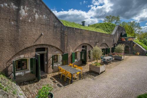 a brick building with a green hill on top of it at Fort Vuren in Vuren