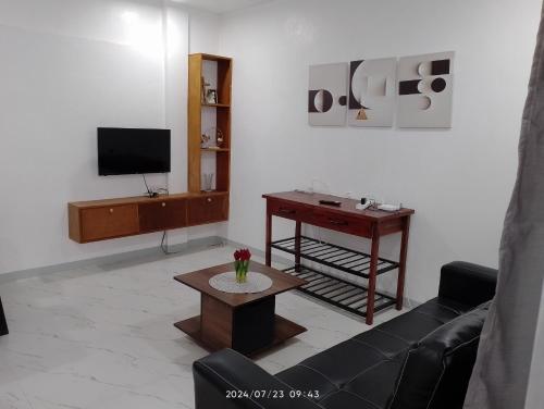 a living room with a couch and a table at Asher's and 3 Marias Transient House in Bolosan