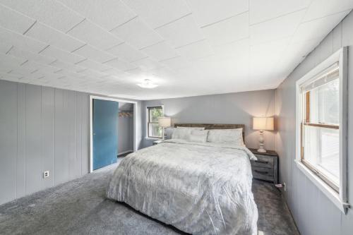 a bedroom with a large bed and a window at Charming Stowe Retreat with Mountain Views home in Stowe
