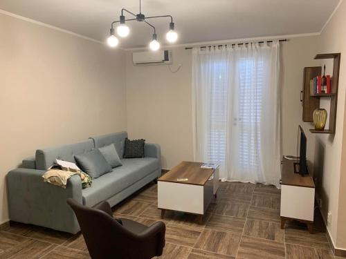 a living room with a blue couch and a table at Chill Topla in Topla
