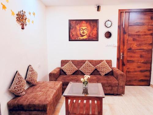 a living room with a couch and a table at Yogvan Luxury 1BHK Apartments Tapovan Rishikesh in Rishīkesh
