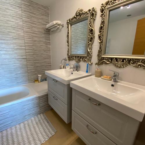 a bathroom with a sink and a mirror and a tub at Casa Paradise 2, Ground Floor Apartment on Mar Menor Golf Resort in Torre-Pacheco