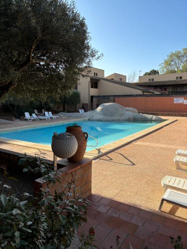 - une piscine avec un vase à côté dans l'établissement Studio mezzanine golf St cyprien, à Saint-Cyprien