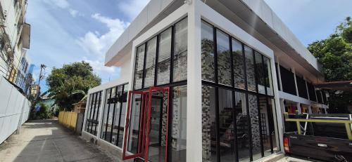 a store front with glass windows on a street at Samui Beach Hostel in Amphoe Koh Samui
