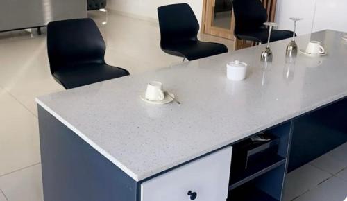 an office with chairs and a counter with cups on it at Ixora AP 2 in Ngor
