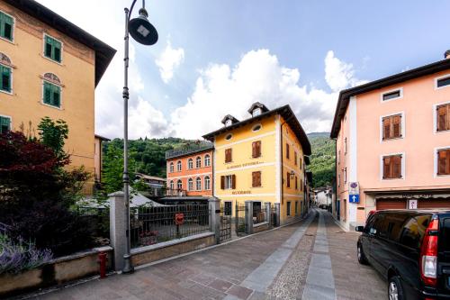 a group of buildings on a street in a town at Hotel Vittoria in Roncegno
