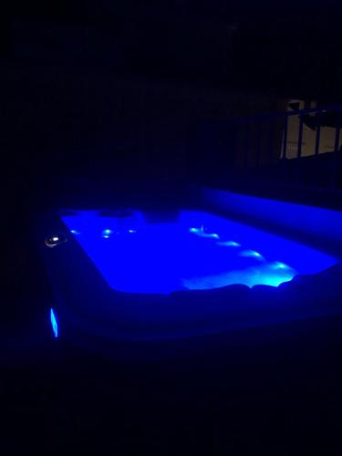 a blue hot tub in a dark room at Evagelia's deluxe villa-Roof Top Jacuzzi in Skopelos Town