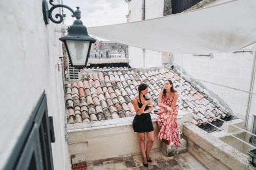 two women standing on the steps of a building at La Casa di Ele in Matera