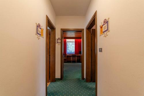 a hallway leading to a room with a table at Hotel St. Pankraz in San Pancrazio dʼUltimo