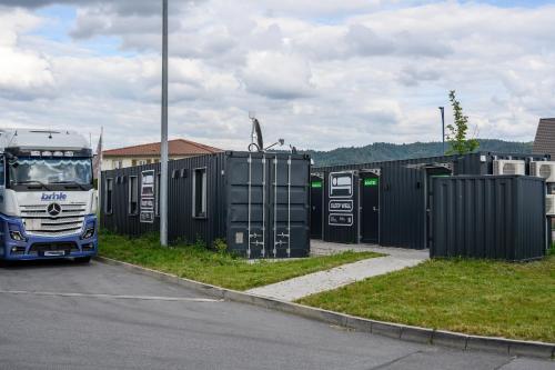 a truck parked in a parking lot next to a bunch ofrecycling at Roatel Hirschberg an der Bergstraße (A5) my-roatel-com in Hirschberg an der Bergstraße