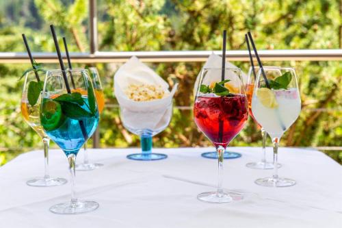 a group of four wine glasses sitting on a table at Hotel St. Pankraz in San Pancrazio dʼUltimo