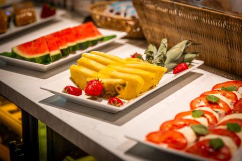 a buffet with several plates of food on display at Hotel St. Pankraz in San Pancrazio dʼUltimo