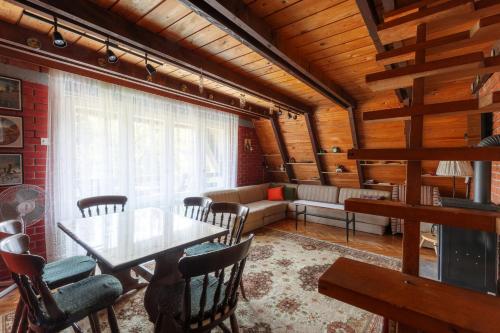 a dining room with a table and chairs at Pet-Friendly - Planinska Vikendica Međurečje in Ivanjica