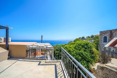 a balcony with a view of the ocean at RODIBLUE VILLAGE Apartments in Rodia