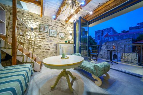 a living room with a table and a balcony at RODIBLUE VILLAGE Apartments in Rodia