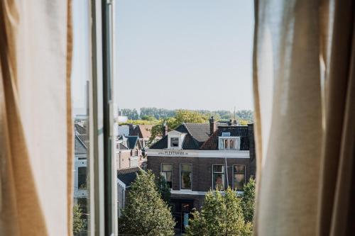a view of a city from a window at Jacques van Marken Erfgoed in Delft