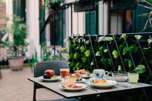 a table with plates of food and drinks on it at Hotel Eden Salò in Salò