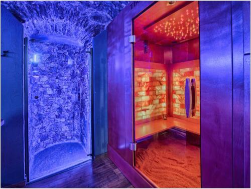a bathroom with a shower with a stone wall at Fantastica Casa Poppo in Bellano