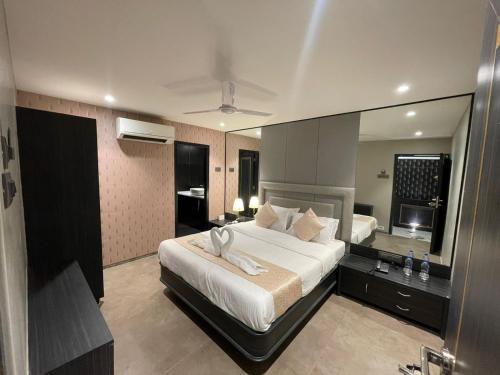 a bedroom with a bed and a large mirror at Gulf Hotel Mumbai- The Boutique Hotel Colaba Mumbai in Mumbai