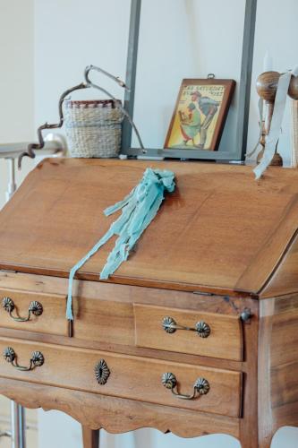 a wooden dresser with a blue umbrella on top of it at Agriturismo L'Elisir di Atena in Moscufo