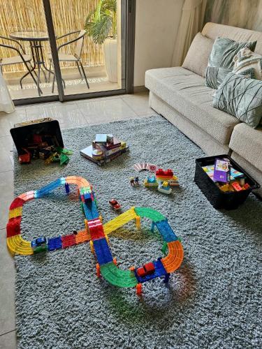 a living room filled with toys on a rug at Jerusalem Center in Jerusalem