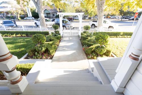a stairway leading to a yard with a white fence at The Queen On Main in Winters