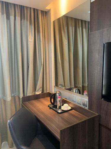 a hotel room with a table and a mirror at Agulu Lake Resort and Conference Centre in Ekwulobia