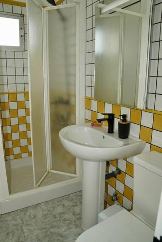 a bathroom with a sink and a shower at Los Adejo in Moya
