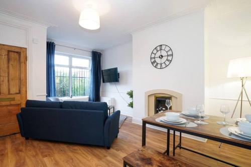 a living room with a couch and a table at 3 Bedroom Home with Free parking in Leeds