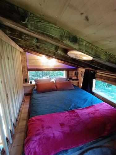 a bedroom with a large bed in a house at Les Étoiles de Bevy Chalet insolite Love Room in Septmoncel