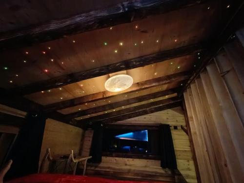 a room with a wooden ceiling with a moon on it at Les Étoiles de Bevy Chalet insolite Love Room in Septmoncel