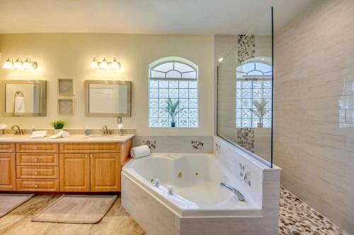 a large bathroom with a tub and a shower at Villa Lazy Days by CoralVilla - comfortable, pool & spa in Shell Point Village