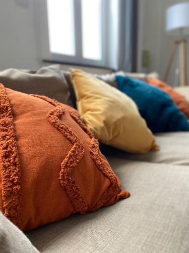 - un ensemble d'oreillers assis sur un canapé dans l'établissement Maison de charme 1920, à Roubaix