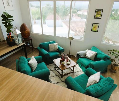 a living room with green couches and a table at 195 sqm luxury apartment in L'Alfas del Pi
