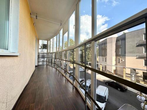 a large room with windows and a balcony at ApartPoltava Затишна квартира в новобудові, панорамний балкон, банківський чек in Poltava
