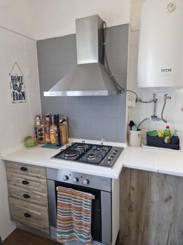 a kitchen with a stove top oven in a kitchen at Horse Riding Country House in Vila Franca de Xira
