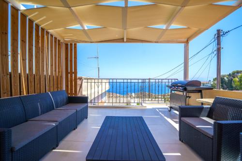 a balcony with benches and a view of the ocean at RODIBLUE VILLAGE Apartments in Rodia