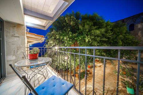 a balcony with a table and a tree at RODIBLUE VILLAGE Apartments in Rodia