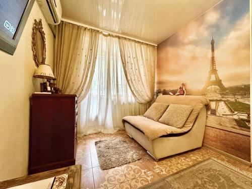 a bedroom with a bed and a painting of the eiffel tower at ApartPoltava Французький шик у центрі Полтави, 4 спальних місця, Корпусний парк in Poltava