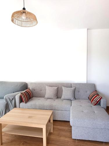a living room with a couch and a coffee table at Apartamentos rurales 'Los Soportales' in Tendilla