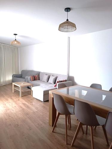 a living room with a couch and a table at Apartamentos rurales 'Los Soportales' in Tendilla